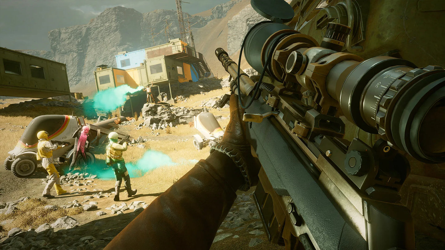 First-person view of a character holding a large weapon in a desert-like environment with structures and people in the background.