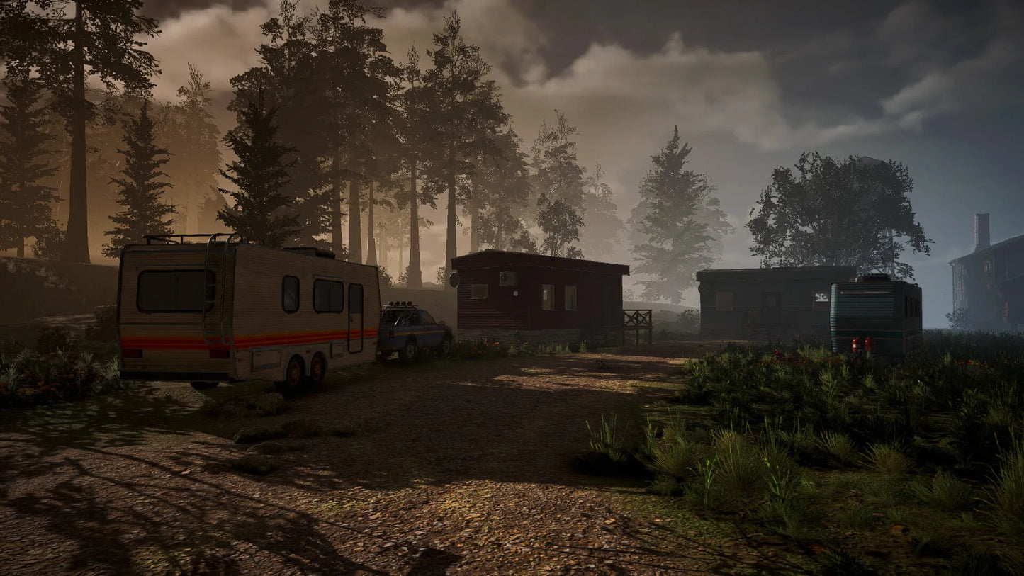 Scenic view of a forest with trailers and vehicles on a dirt road