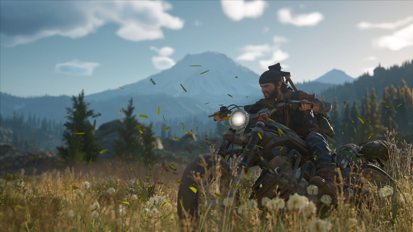 Person riding a motorcycle in a mountainous landscape with a scenic view.