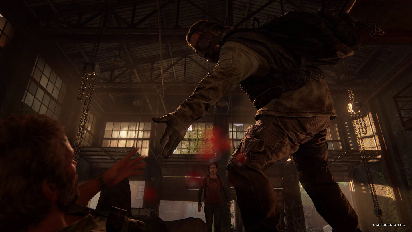 Two characters in a tense confrontation inside a dimly lit industrial building.
