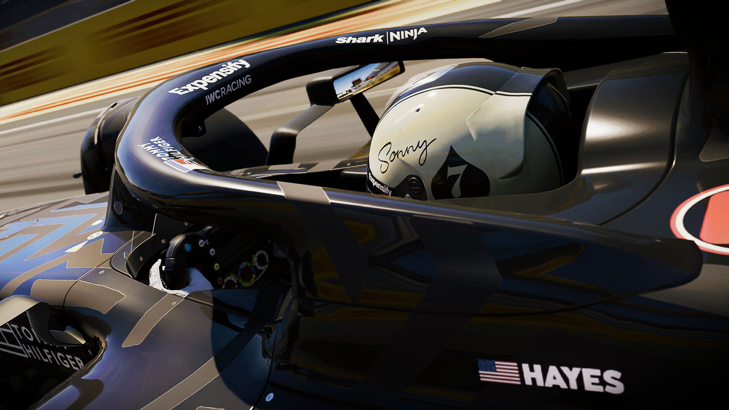 Close-up of a Formula 1 car with a driver's helmet inside, on a track.