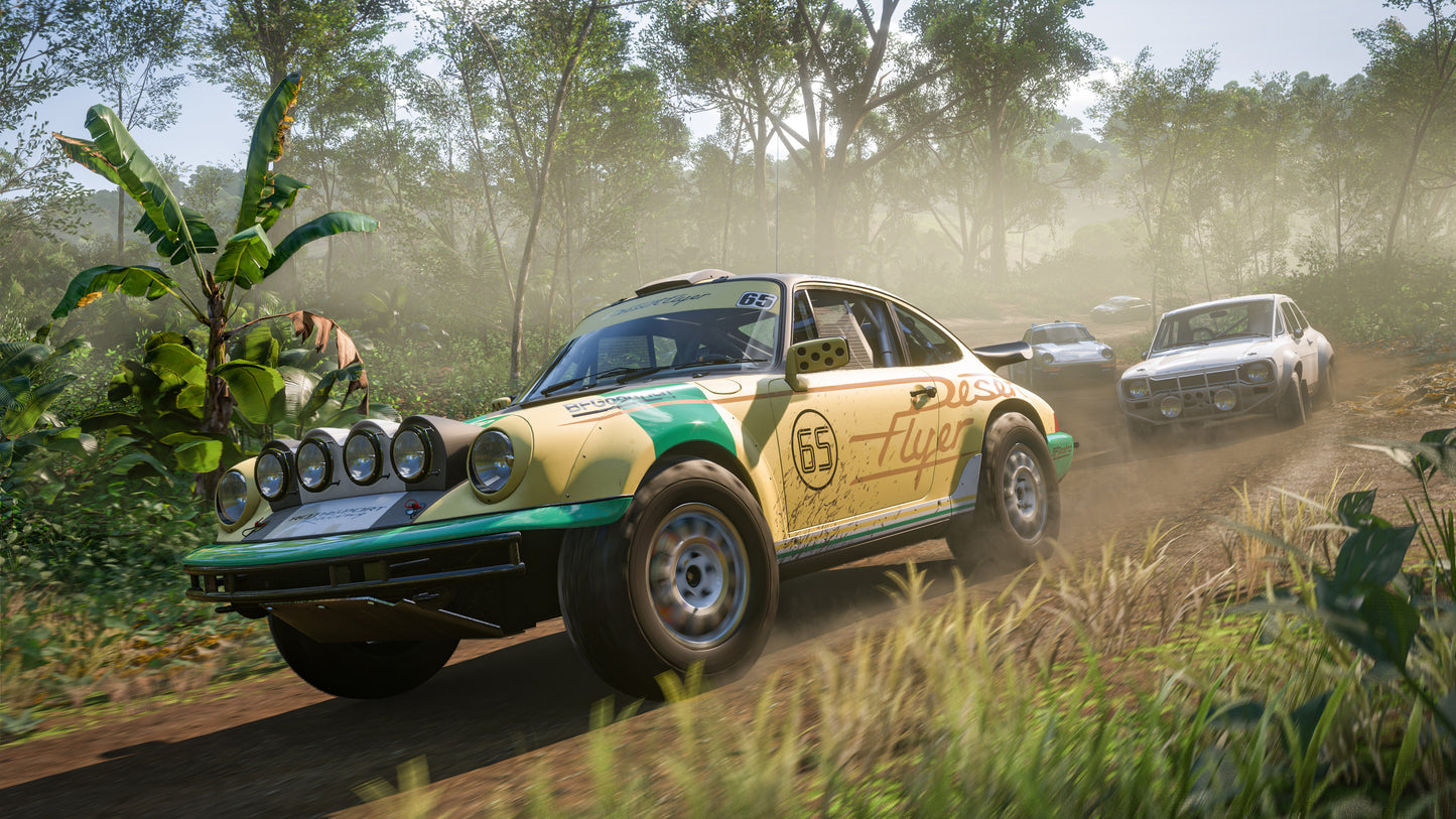 Vintage rally car on a dirt track with a forest background