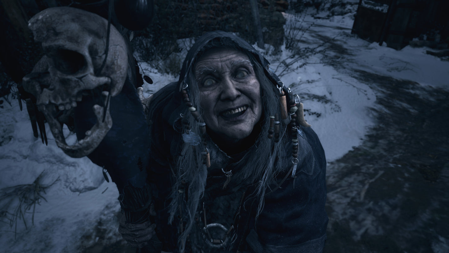 Person in dark clothing holding a skull in a snowy, forested area