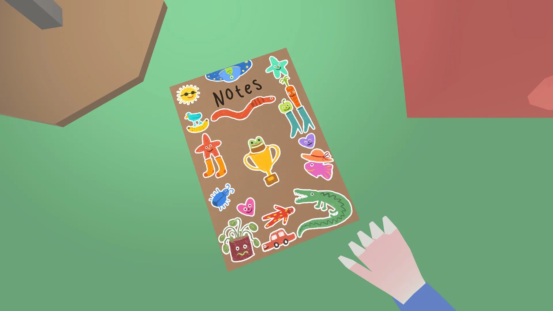 Notebook with colorful stickers on a green surface