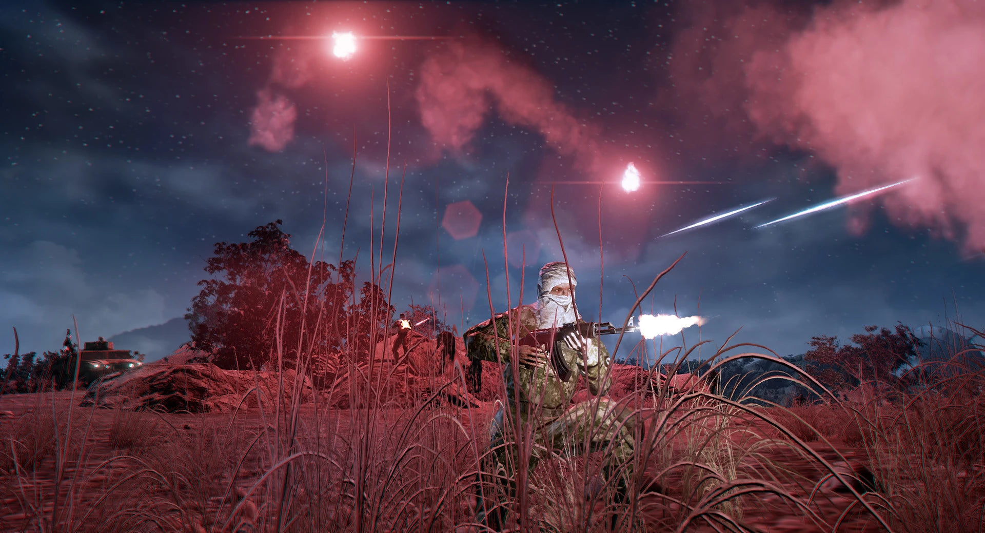 Soldiers in camouflage with weapons in a field at night, illuminated by red lights.