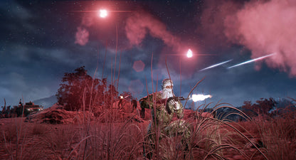 Soldiers in camouflage with weapons in a field at night, illuminated by red lights.