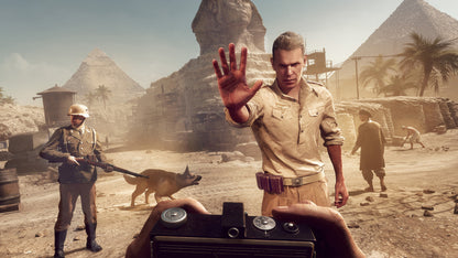 Man in a desert setting with pyramids and soldiers in the background