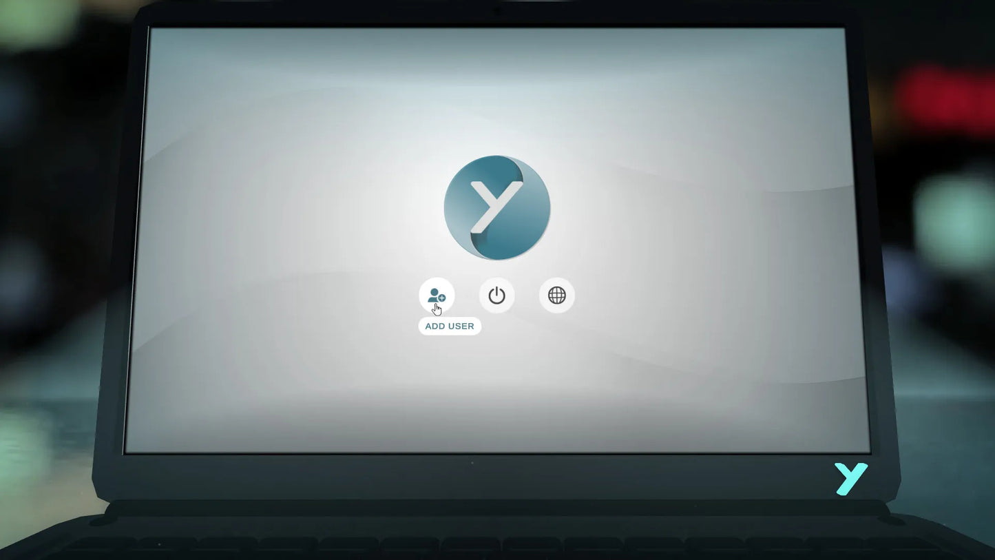 Laptop displaying a loading screen with a logo on a blurred background