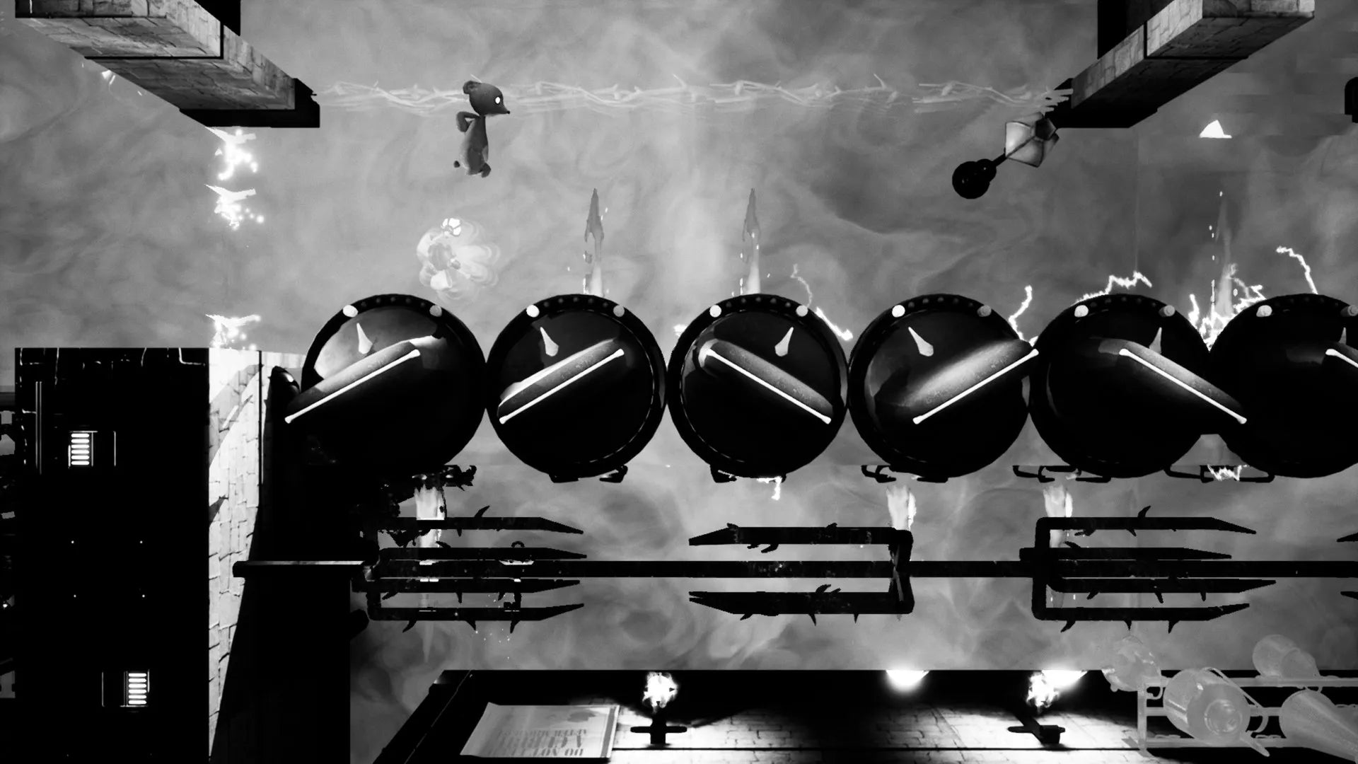 Black and white image of a mechanical setup with large cylindrical objects and pipes.