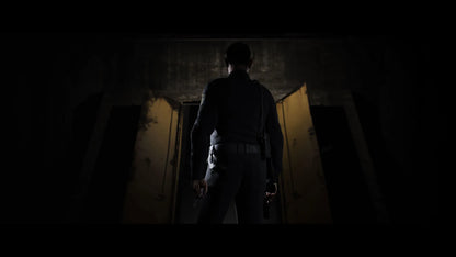 Person holding a gun in a dimly lit room