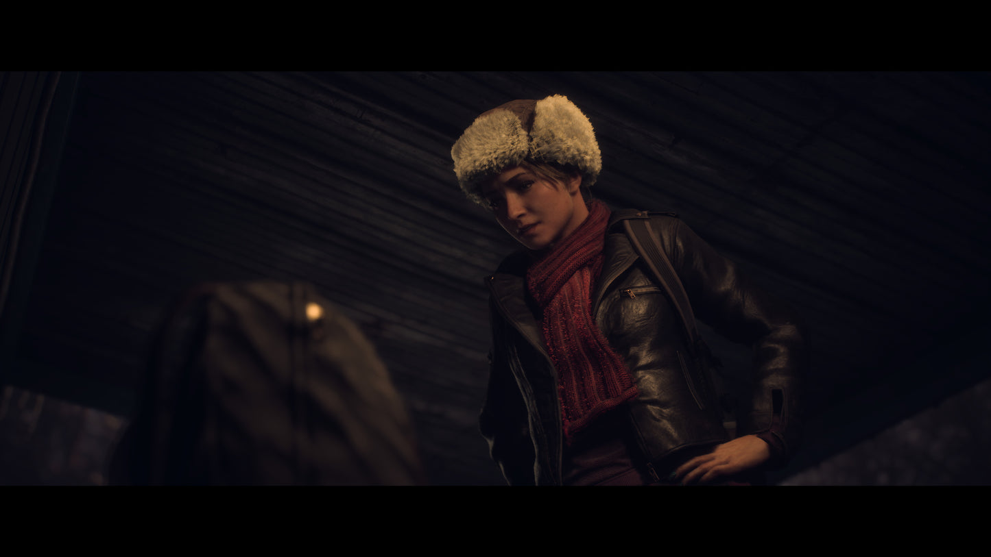 Person wearing a fur hat and scarf in a dark setting