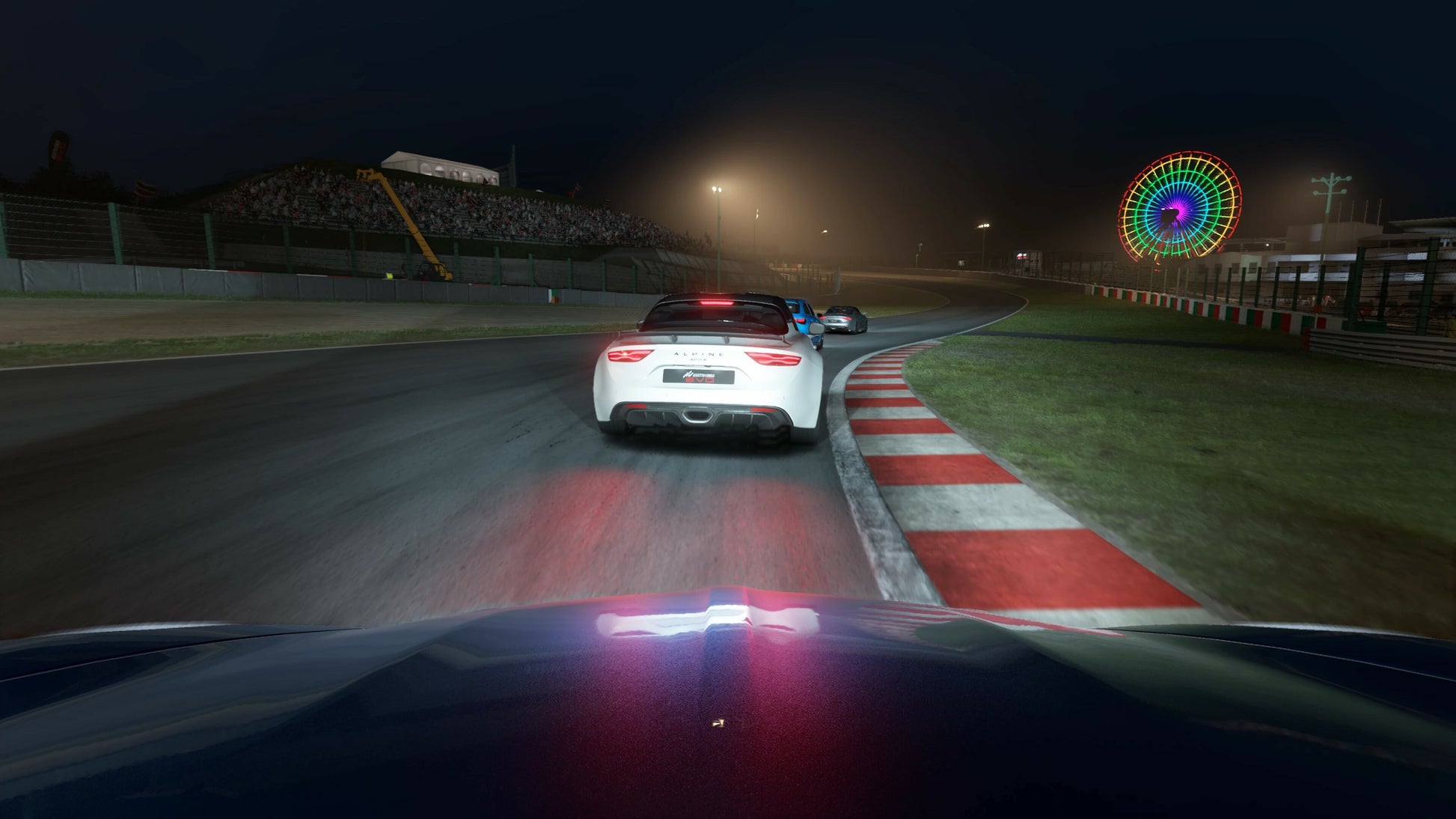 Car racing on a track at night with colorful lights in the background
