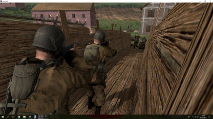 Two soldiers in a military setting with wooden structures and buildings in the background.