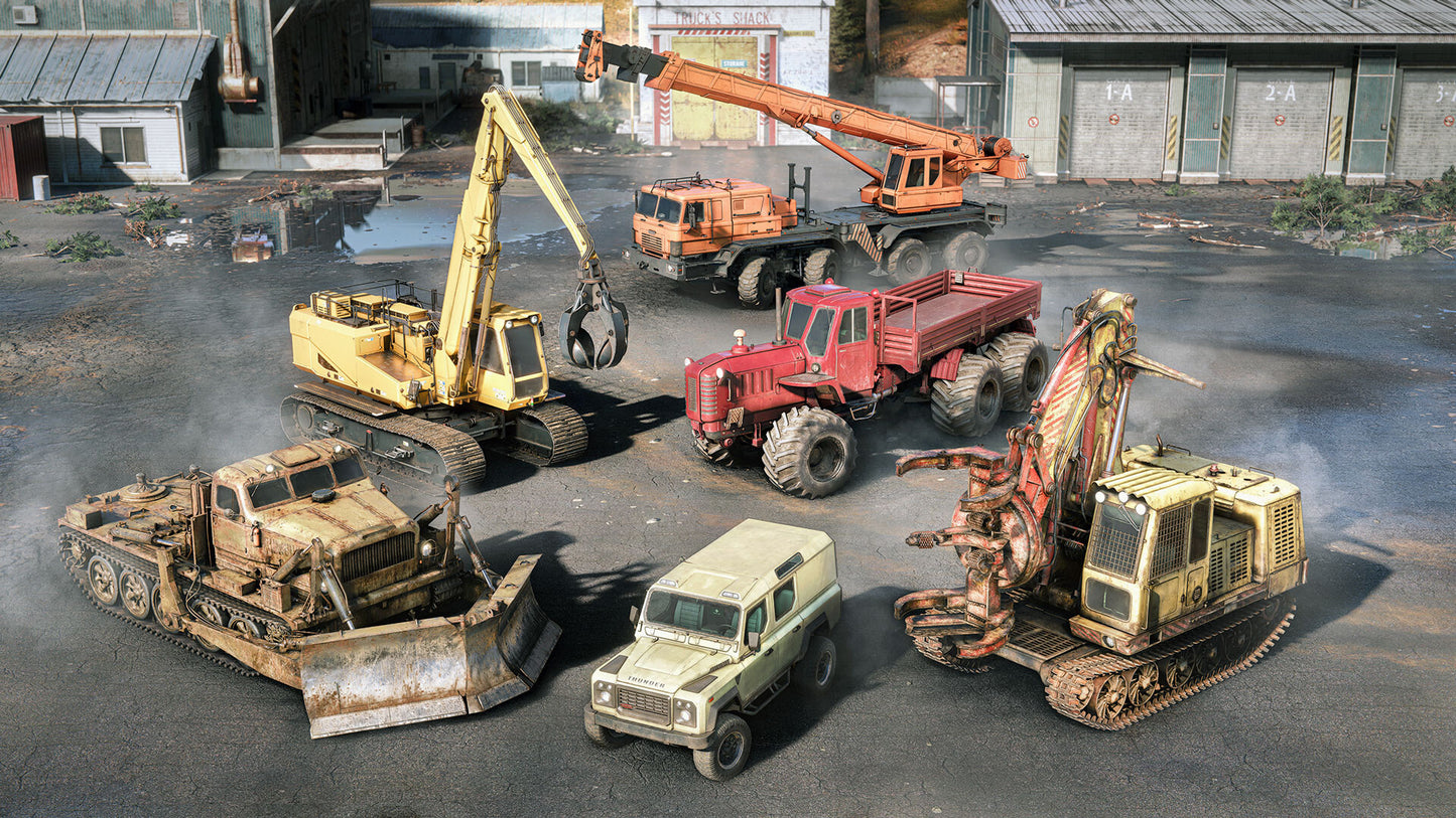 Collection of old and worn construction vehicles on a concrete surface.