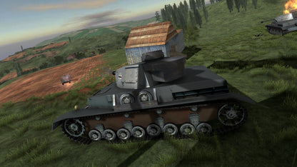 Tank in a grassy field with a barn and another tank in the background