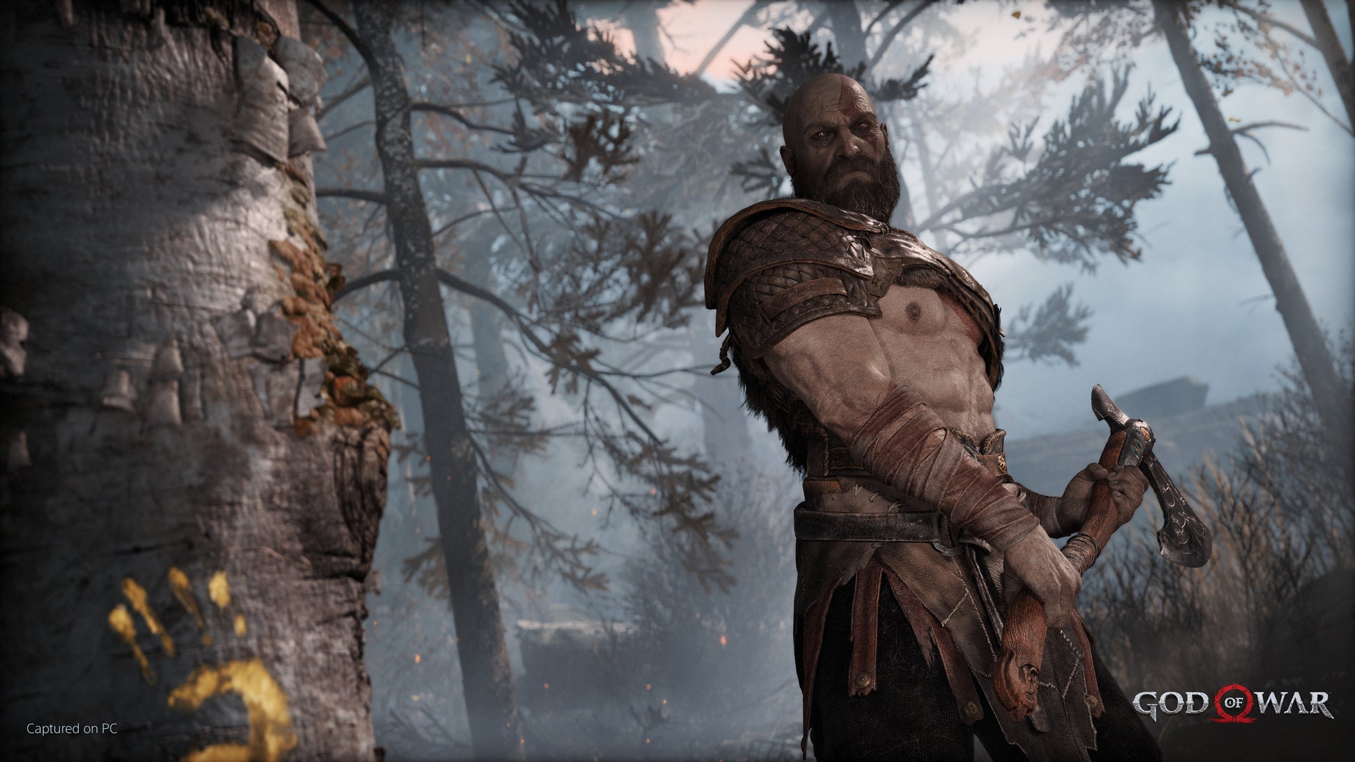 Character from 'God of War' holding an axe in a forest setting