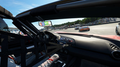 Racing car interior view on a race track with other cars and spectators.