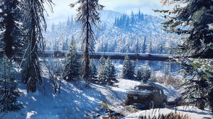 Jeep in a snowy forest with a mountain in the background
