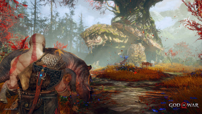 Video game scene with a warrior and a large creature in a forest setting, featuring the 'God of War' logo.