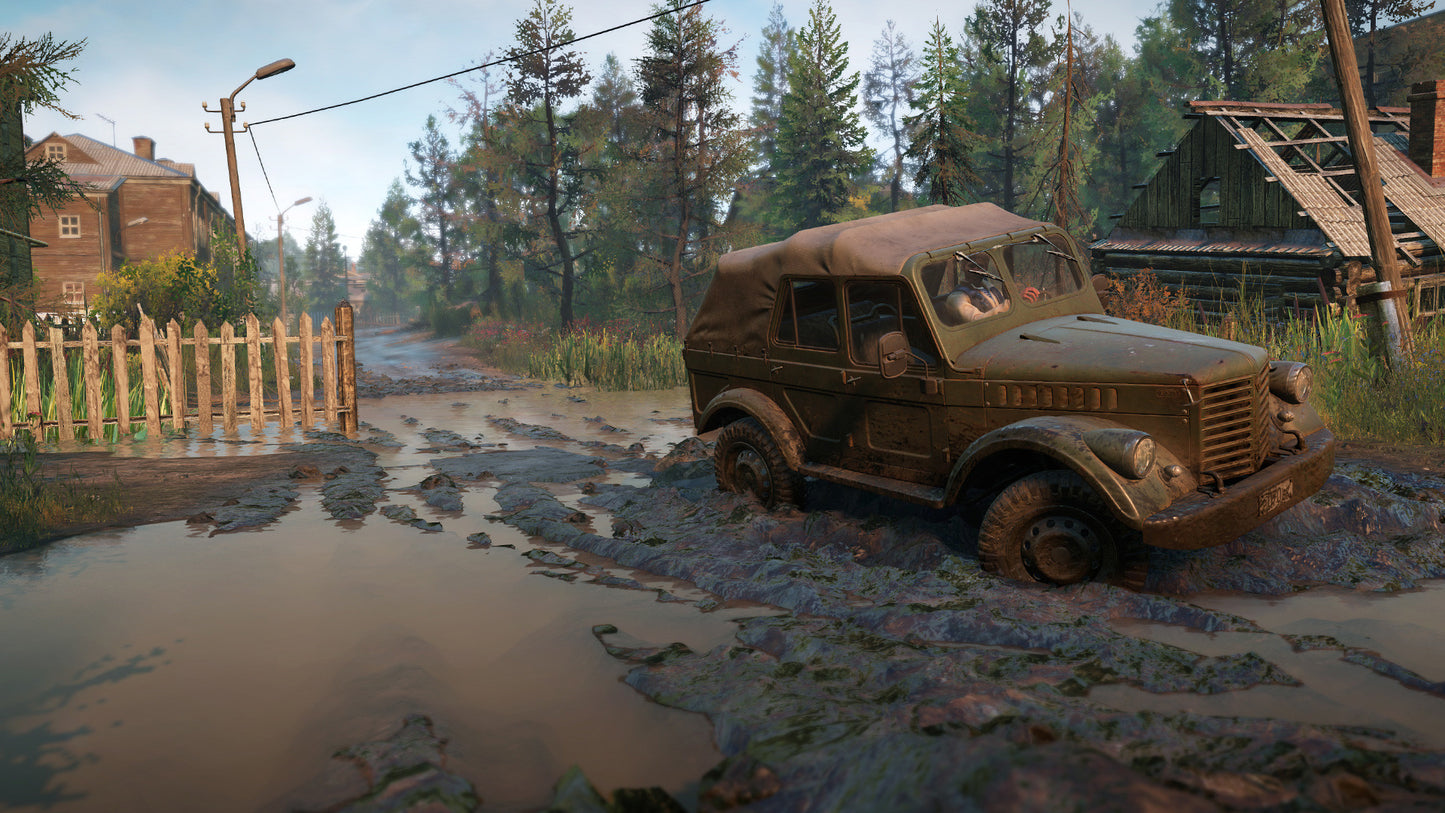 Vintage military jeep on a muddy road with a rustic village background