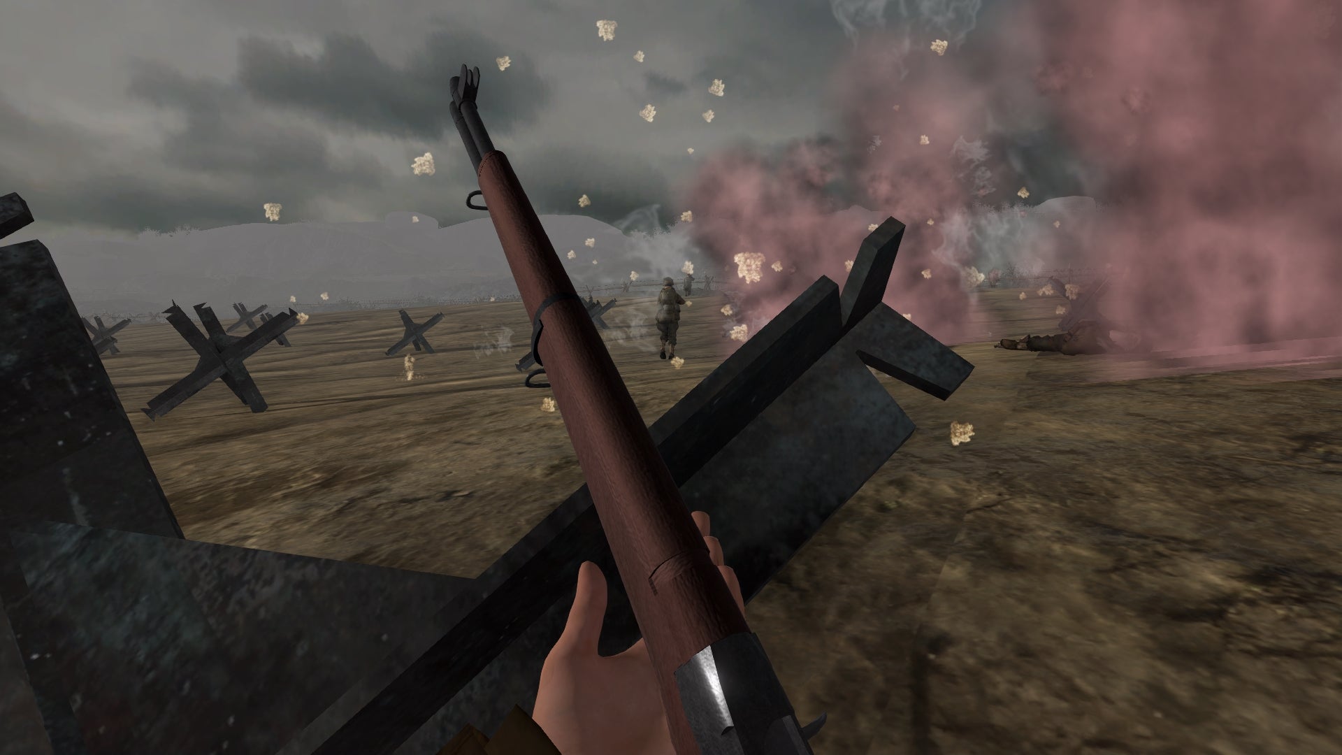 First-person view of a gun with a battlefield scene in the background