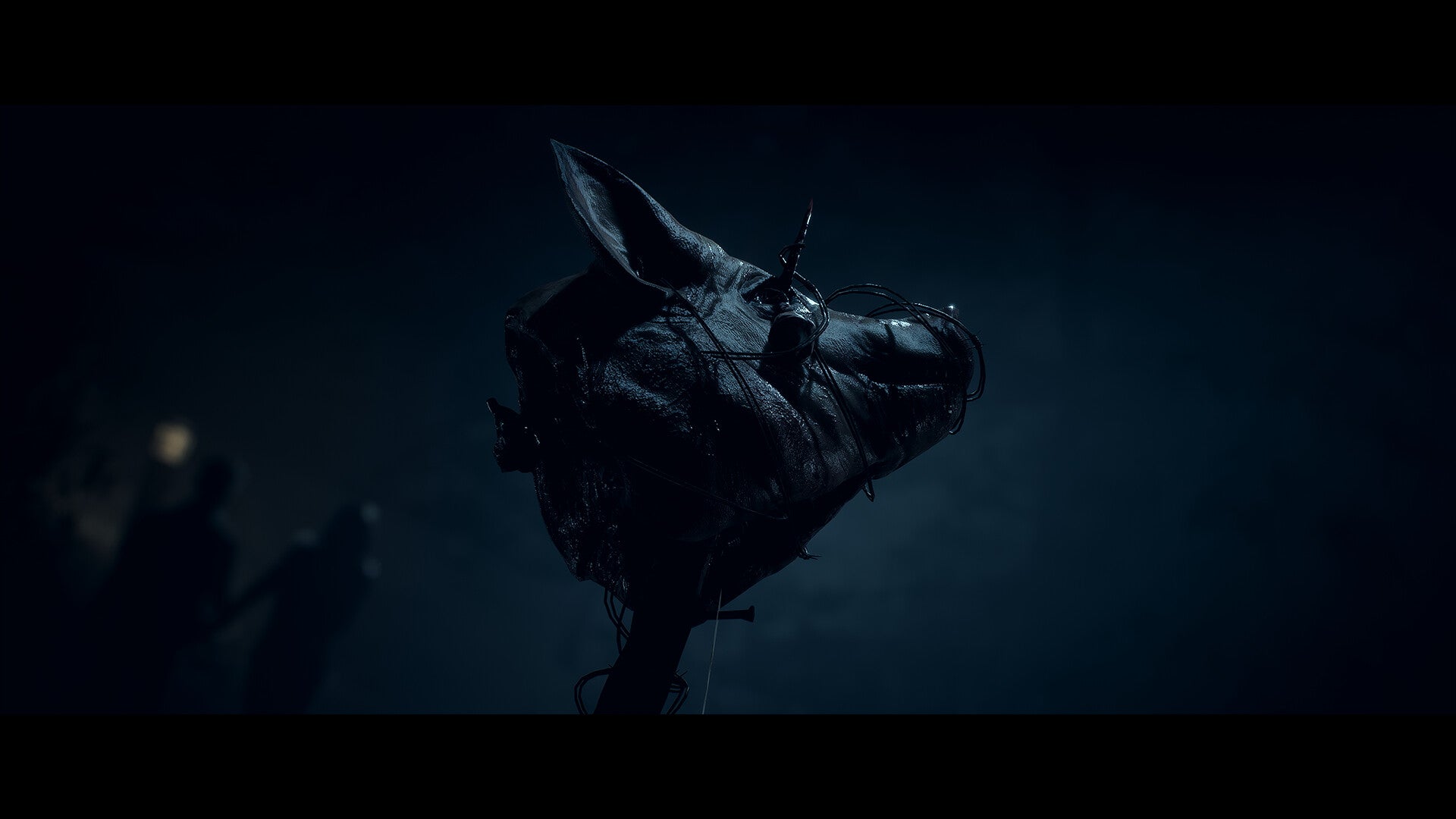 Dark, shadowy figure with a horse head silhouette against a dark background