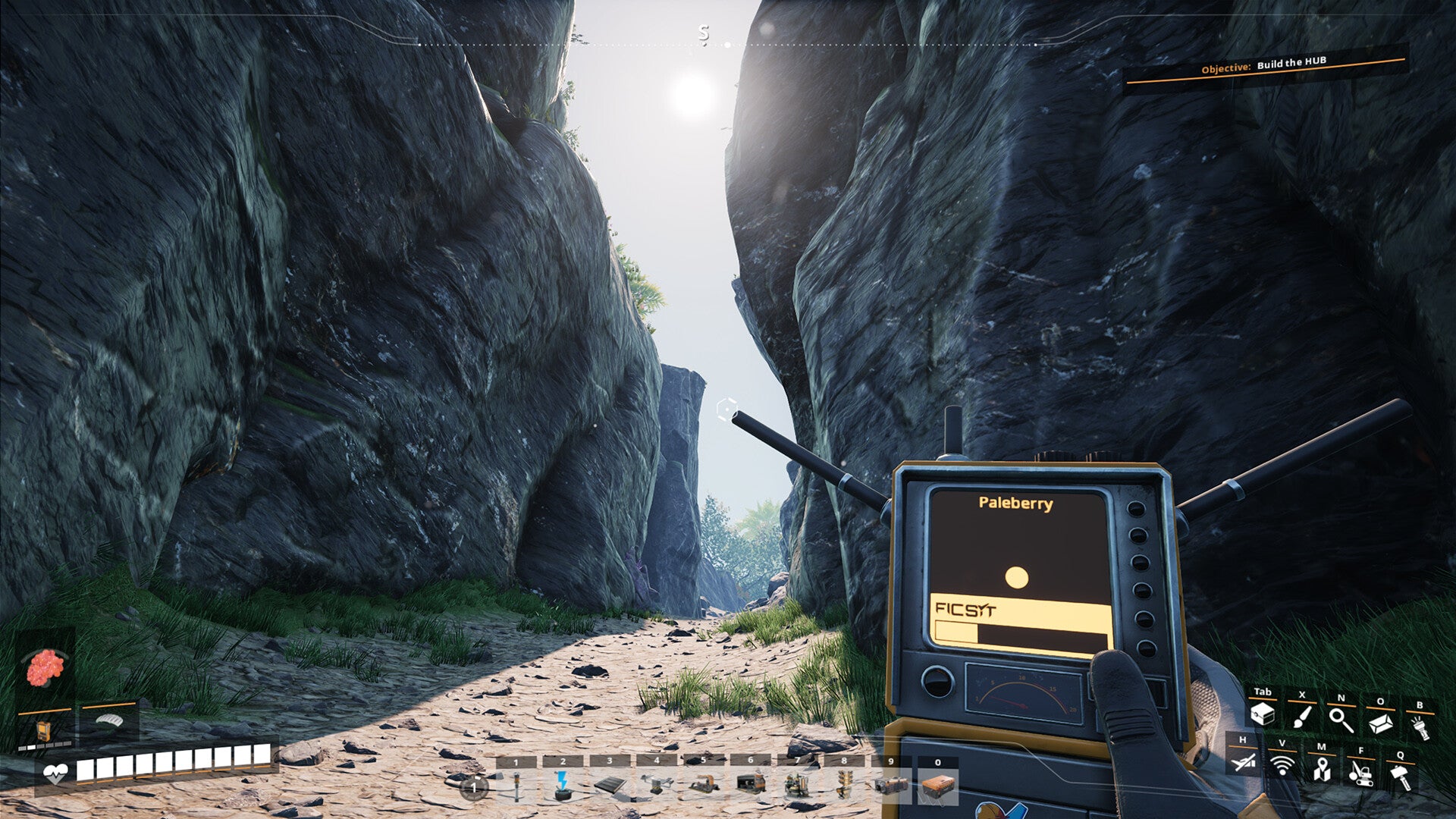 Hand holding a radio device with rocky landscape in the background