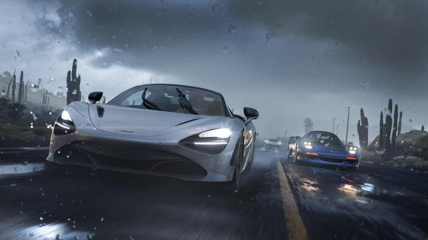 Two sports cars racing on a wet road with cacti in the background