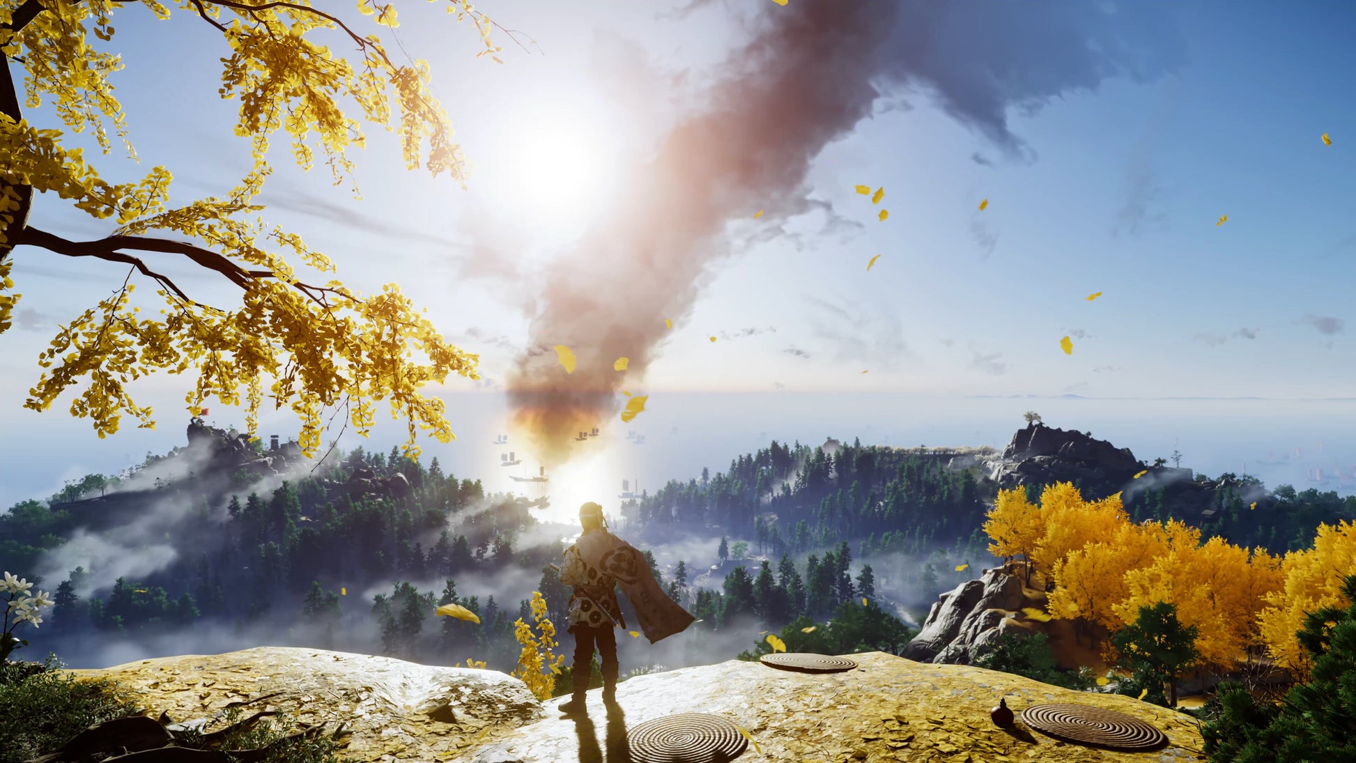 Person standing on a rocky outcrop with a large smoke cloud and autumn foliage in the background
