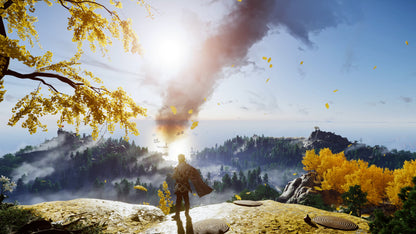 Person standing on a rocky outcrop with a large smoke cloud and autumn foliage in the background