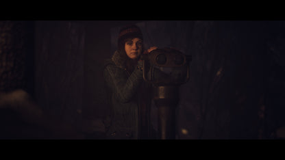 Person holding a vintage binoculars-like device in a dark setting