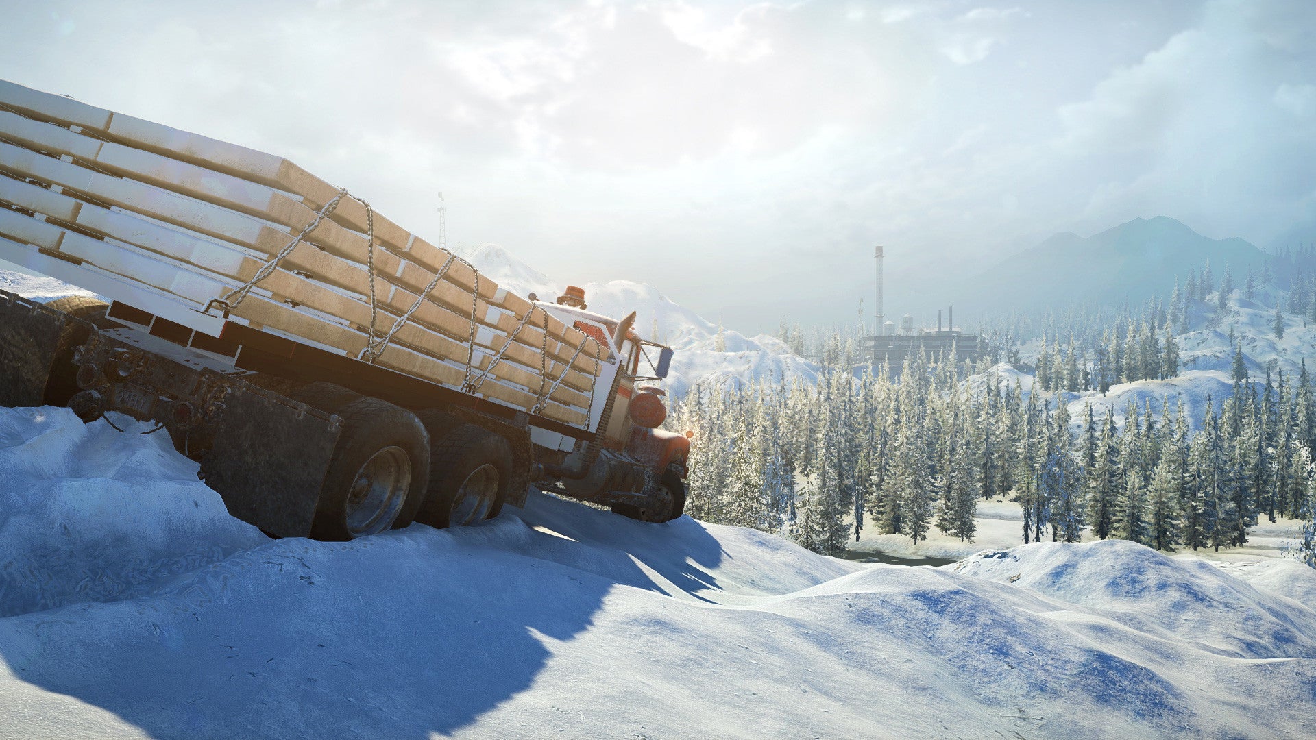 Truck loaded with logs driving on a snowy road with trees and mountains in the background