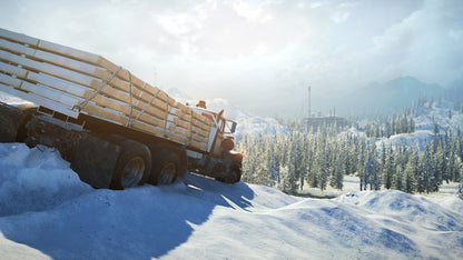 Truck loaded with logs driving on a snowy road with trees and mountains in the background