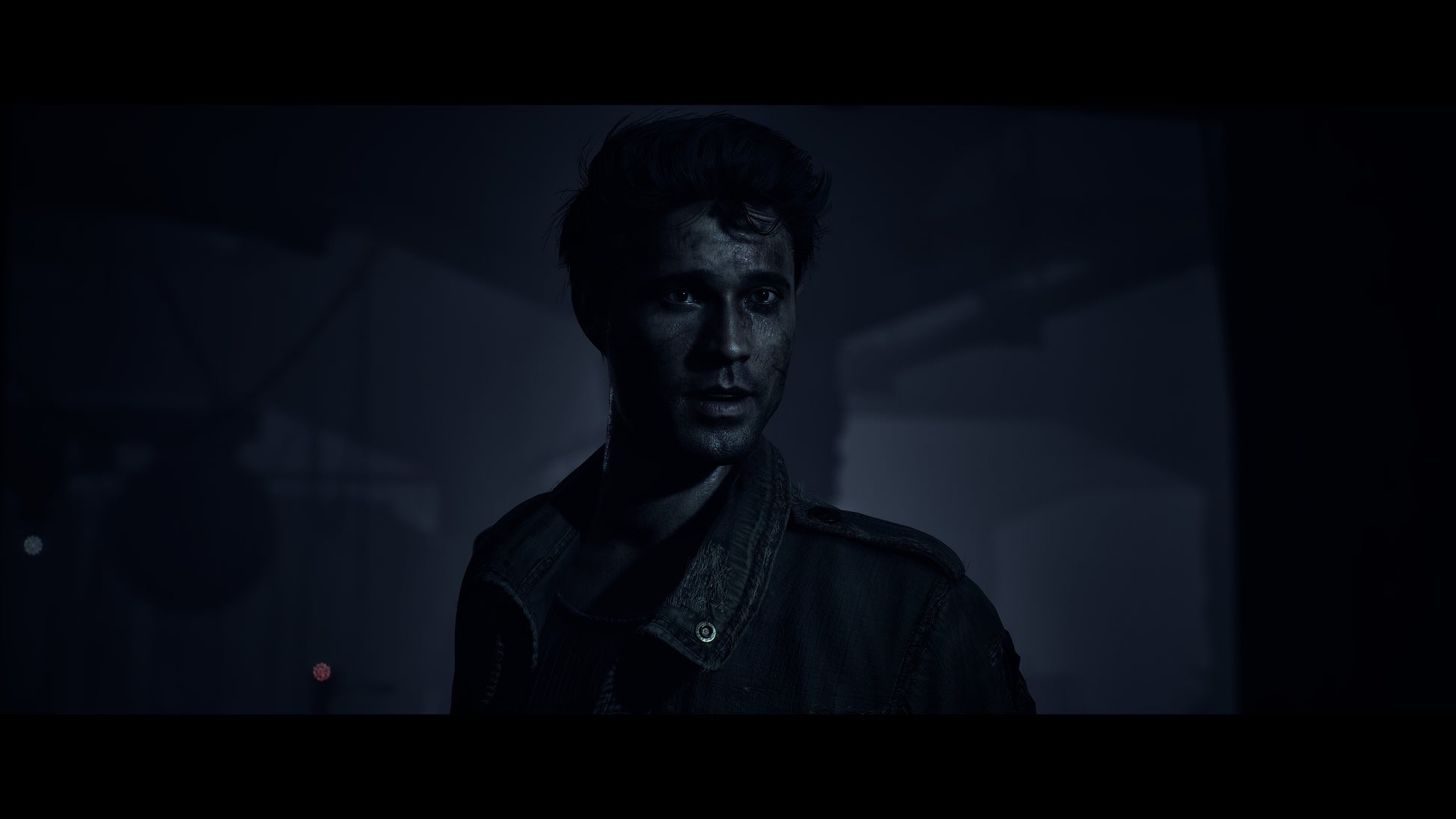 Person wearing a dark uniform in a dimly lit setting